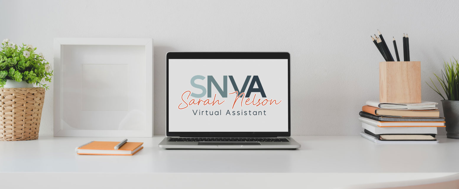 Laptop sat on a clean desk showing Sarah Nelson VIirtual Assistant Logo on screen. Also on desk are stacked notepads, pens and a potted plant.